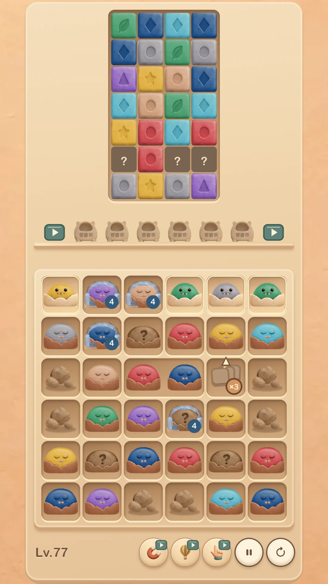 Not Before Bed 01 gameplay at level 77, with colourful blocks above a tray of little monsters.